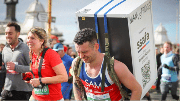 Photo of a Brighton Half Marathon runner carrying a refrigerator on his back