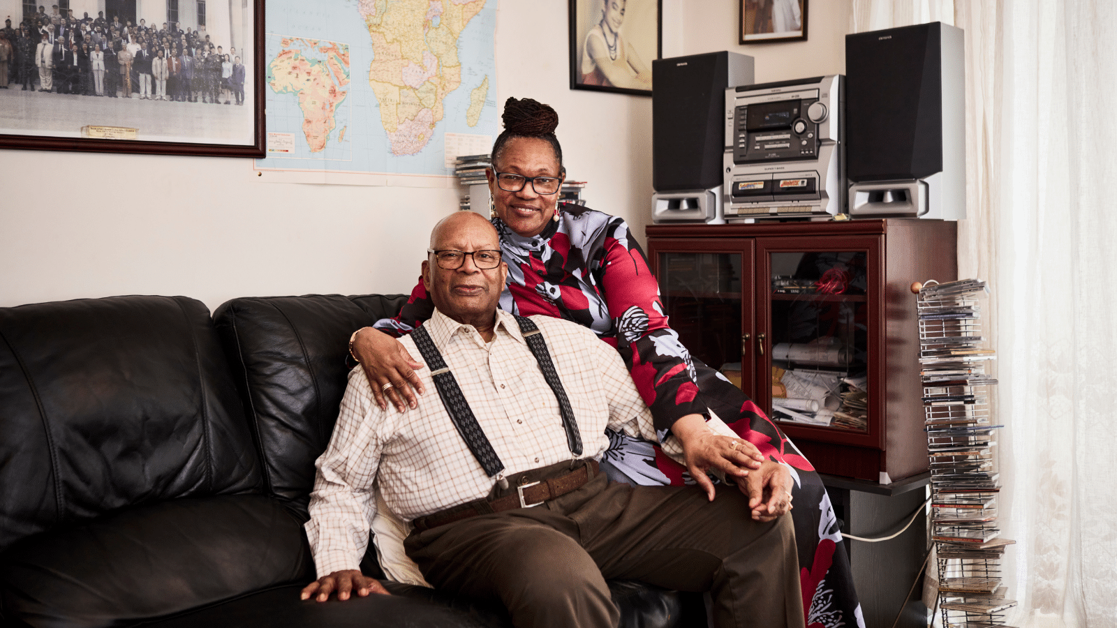 Image showing two people together on a couch smiling.