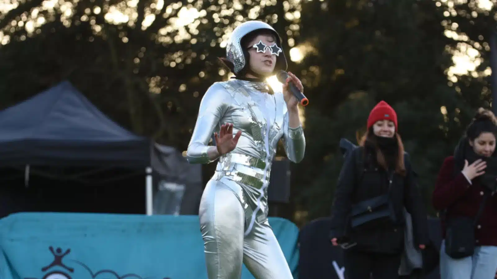 Photo showing Freya dressed as the "human disco ball", leading a session at a community fitness event.